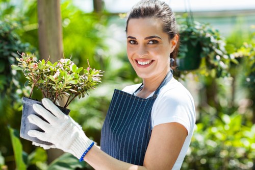Worker using well-maintained gardening machinery with proper PPE
